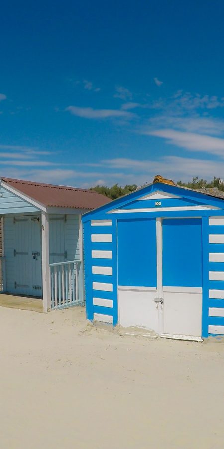 Traditional beach huts on fine golden sand at West Wittering Beach West Sussex England UK