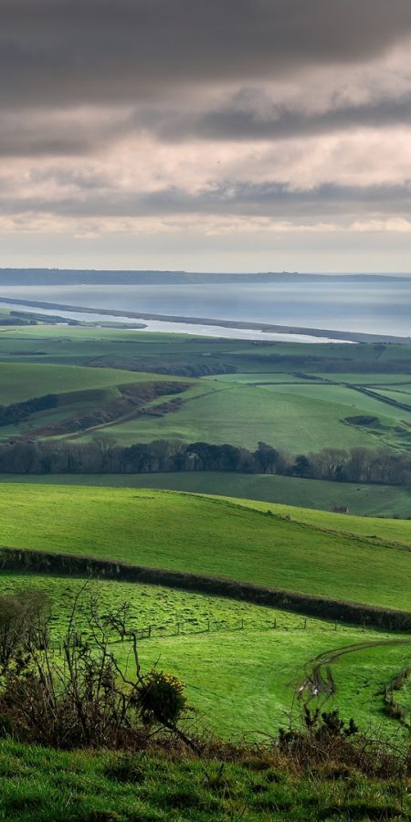 Panoramic view of Portand and Chesil Beach from the hill tops near Abbotsbury in Dorset, UK